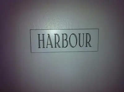 a sign on a wall with the word harbourg at Ashbank Bed & Breakfast in Drymen