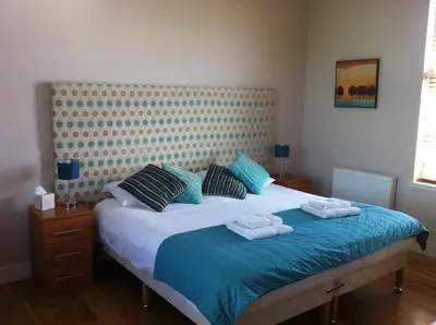 a bedroom with a bed with two towels on it at Ashbank Bed & Breakfast in Drymen