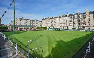 a soccer field in front of a large building at Comely Bank Apartment in Edinburgh