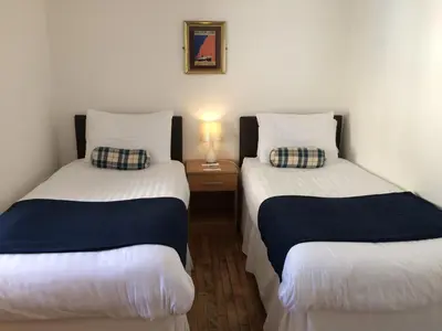 two beds sitting next to each other in a room at Starfish Rooms in Tarbert
