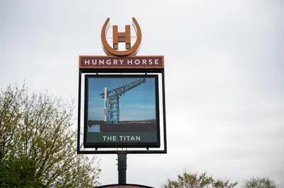a sign for a huryy house and a crane at The Titan By Greene King Inns in Clydebank
