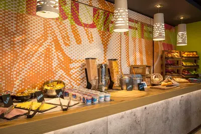 a kitchen with a counter with food on it at ibis budget Glasgow in Glasgow