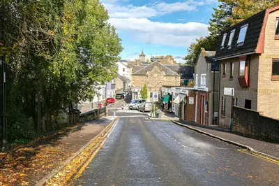 an empty street in a small town with buildings at 6 Beech Court in Dunblane