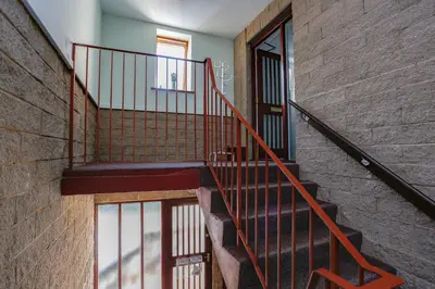 a staircase in a building with a brick wall at 6 Beech Court in Dunblane