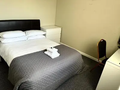 a bedroom with a bed with towels on it at Nithsdale Hotel in Sanquhar