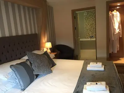 a hotel room with a bed with two towels on it at Nithsdale Hotel in Sanquhar