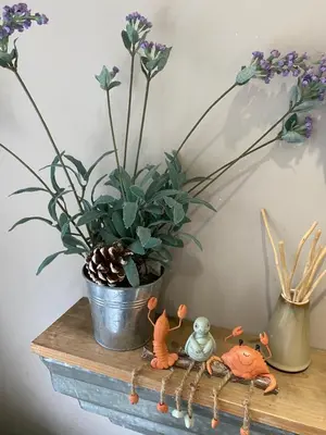 a table with a potted plant and a pot of flowers at Sea Hollies in Aberdour