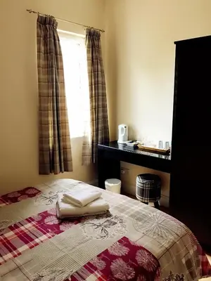 a bedroom with a bed with two towels on it at Acer Lodge Guest House in Edinburgh