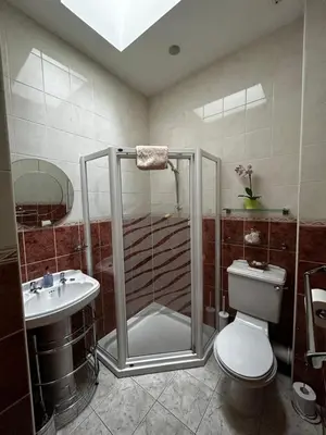a bathroom with a shower and a toilet and a sink at Acer Lodge Guest House in Edinburgh