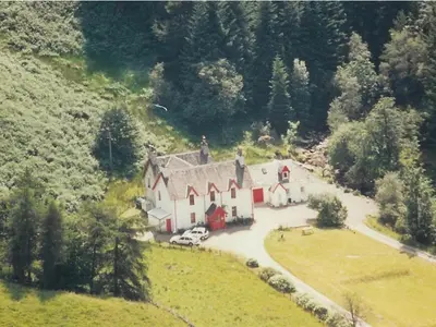 an aerial view of a large house on a hill at Inverardran House in Crianlarich