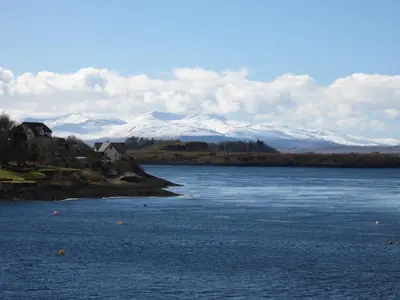 a large body of water with snow capped mountains in the background at Ronebhal Guest House in Oban