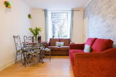 a living room with a couch and a table at Watson Crescent in Edinburgh