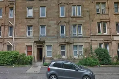 a silver car parked in front of a brick building at Watson Crescent in Edinburgh