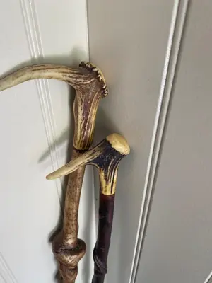 a pair of hunting weapons hanging on a wall at Woodland Cabins, Glencoe in Ballachulish