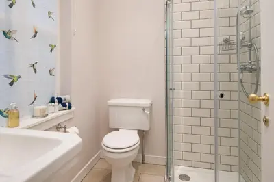 a bathroom with a toilet and a glass shower at East Lodge in Crieff