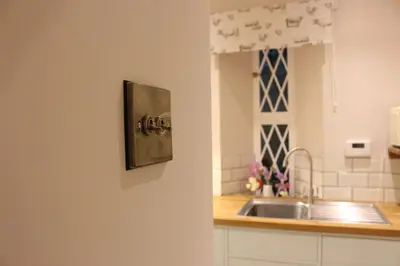 a white kitchen with a sink and a counter at East Lodge in Crieff