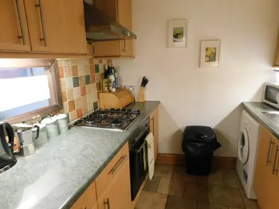 a kitchen with a stove and a counter top at Fountainbridge Flat in Edinburgh