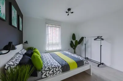 a bedroom with a bed and a window at SuperbSleep Apartments in Glasgow