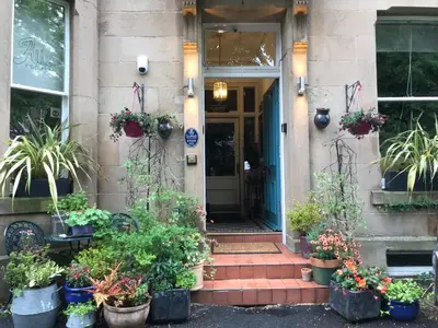 a front door of a building with potted plants at Albyn Townhouse in Edinburgh