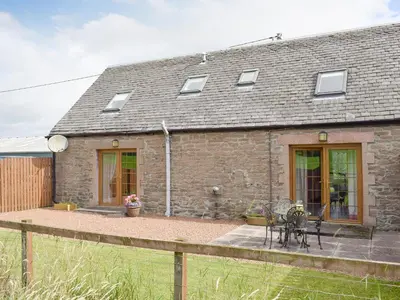 a stone house with a patio in front of it at The Ploughmans - Uk5531 in Kepculloch