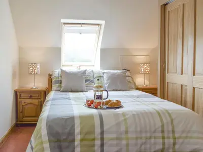 a bedroom with a bed with a tray of food on it at The Ploughmans - Uk5531 in Kepculloch