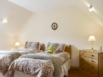 a bedroom with two beds and a dresser at The Stables - Uk5532 in Kepculloch