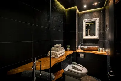 a black bathroom with a sink and a toilet at The Alamo Guest House in Glasgow