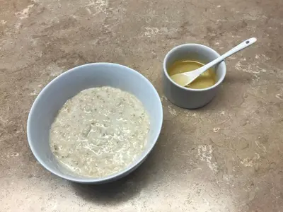 a bowl of cereal and a bowl of soup on a table at glenardran house in Crianlarich