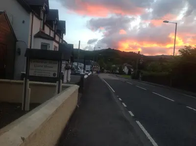 an empty street with a sunset in the background at glenardran house in Crianlarich