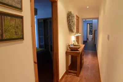 a hallway with a table with a lamp on it at Dundas Flat, 1 bedroom, Comrie in Comrie