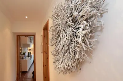 a wreath hanging on a wall in a hallway at Dundas Flat, 1 bedroom, Comrie in Comrie