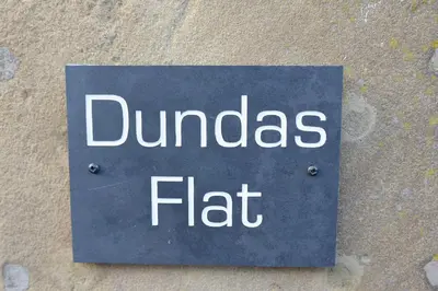 a sign that reads dundas flat on a wall at Dundas Flat, 1 bedroom, Comrie in Comrie