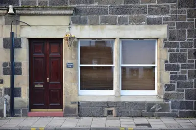 a building with two doors and two windows at Dundas Flat, 1 bedroom, Comrie in Comrie