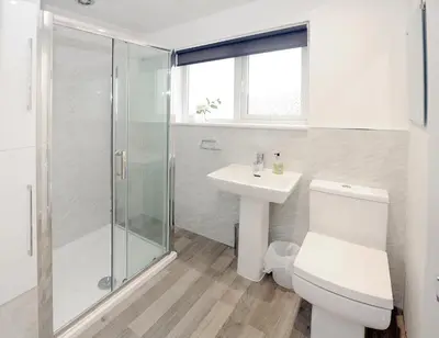 a bathroom with a toilet and a sink and a shower at Three Bedroom Spacious House in Stirling