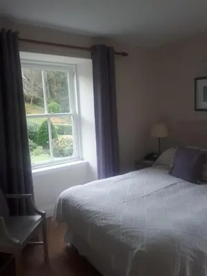 a bedroom with a bed and a window at Bridgend Hotel in Bridgend