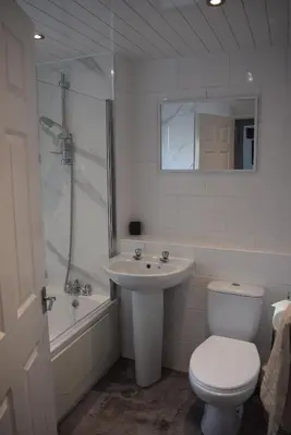 a bathroom with a toilet and a sink and a shower at 3 Bedroom-Kelpies Serviced Apartments Burns in Falkirk