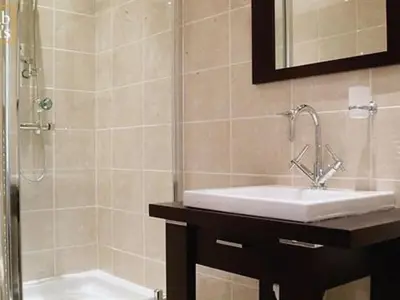 a bathroom with a sink and a shower at Rab Ha's in Glasgow