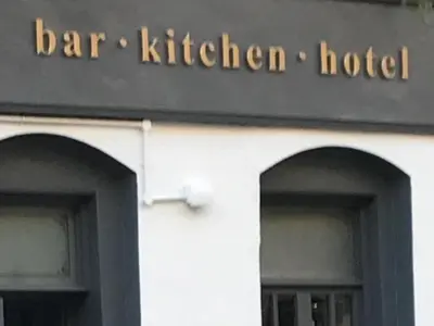 a sign for a bar kitchen hotel on a building at Rab Ha's in Glasgow