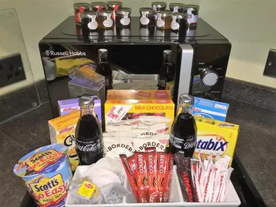 a counter with endorsed food and soda bottles at Castle Gait, Paisley in Paisley