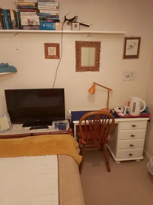 a bedroom with a desk with a computer and a chair at Homely Haven, Dunfermline in Dunfermline