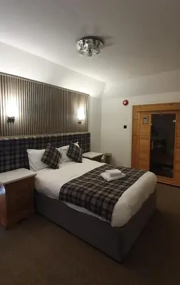 a bedroom with a large bed in a room at The Grey Gull Hotel in Ardrishaig