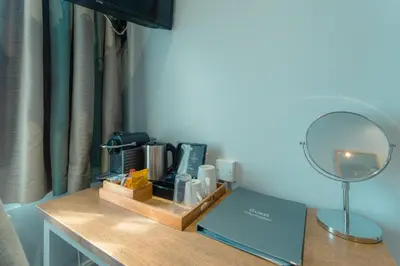 a desk with a mirror and other items on it at West Port Hotel in Linlithgow