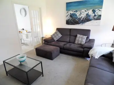 a living room with a couch and a table at Signature - Brambling House in Coatbridge