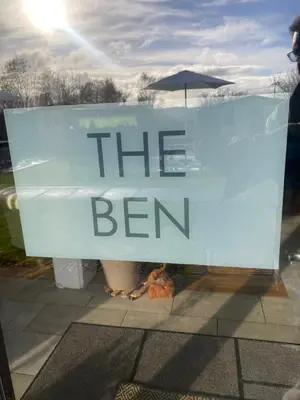 a sign in a window that reads the beer at loch lomond apartments in Alexandria