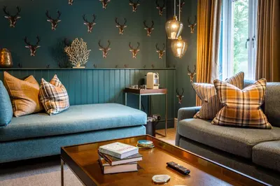 a living room with two couches and a coffee table at Auchrannie Resort in Brodick