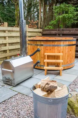 a toaster sitting on a patio next to a wooden tub at Auchrannie Resort in Brodick
