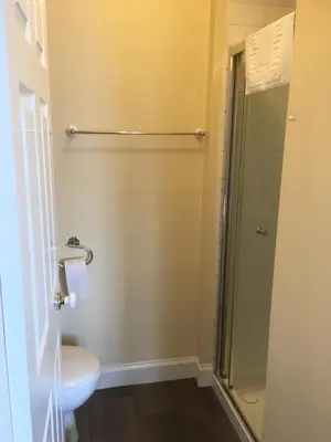a bathroom with a shower and a toilet and a sink at Dunivaig B&B in Tarbert