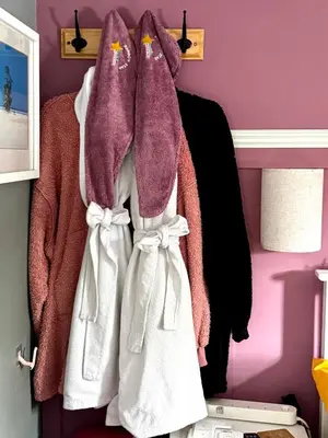 a bunch of coats hanging on a rack in a room at Bumble’s Barn in Slamannan
