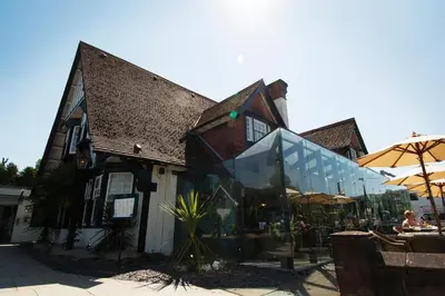 a building with a store with a glass storefront at Tullie Inn in Balloch