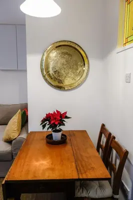 a dining room table with a plate on the wall at Quiet Ground Floor Mews Flat and parking in Edinburgh